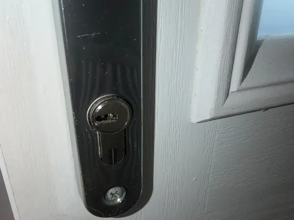 Euro cylinder in a black handle plate on a white composite door