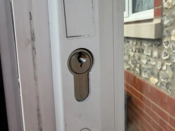 Close-up of a euro cylinder in a white uPVC handle plate