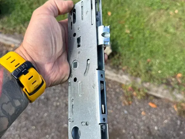 Locksmith holding a replacement uPVC multipoint lock gearbox