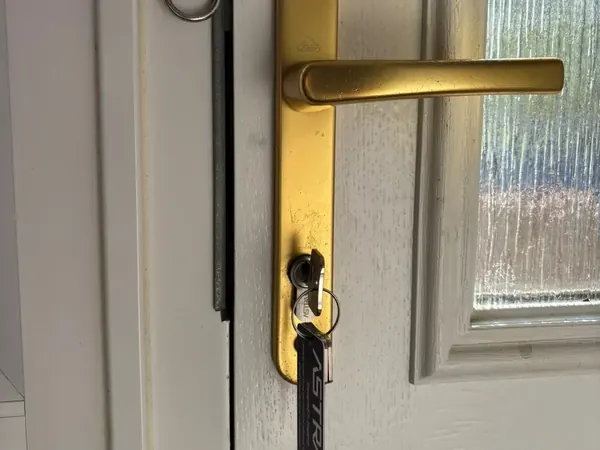 Gold lever handle and euro cylinder with keys on a uPVC door